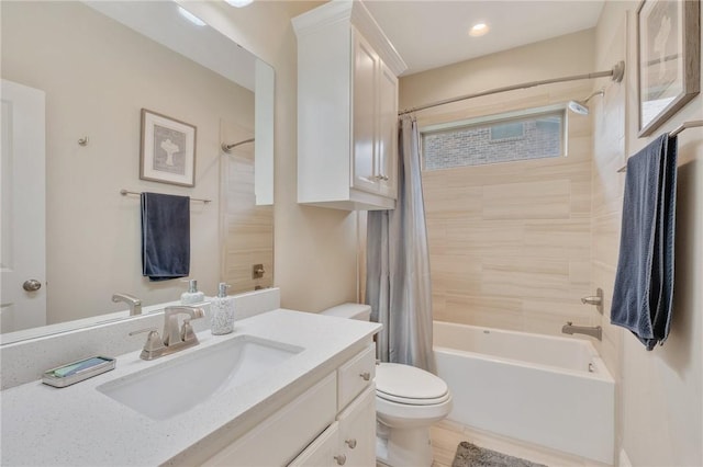 bathroom with vanity, shower / bath combo, and toilet