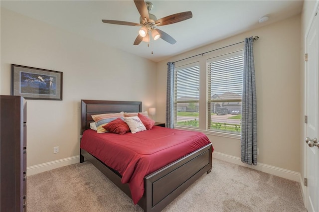 carpeted bedroom with baseboards and ceiling fan