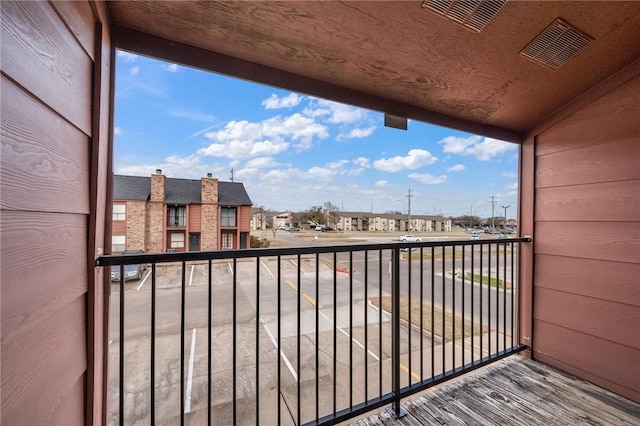 balcony featuring visible vents and a residential view