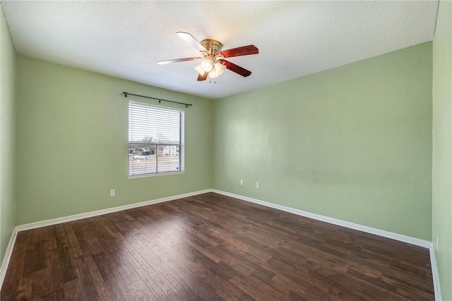 unfurnished room with a ceiling fan, dark wood finished floors, a textured ceiling, and baseboards