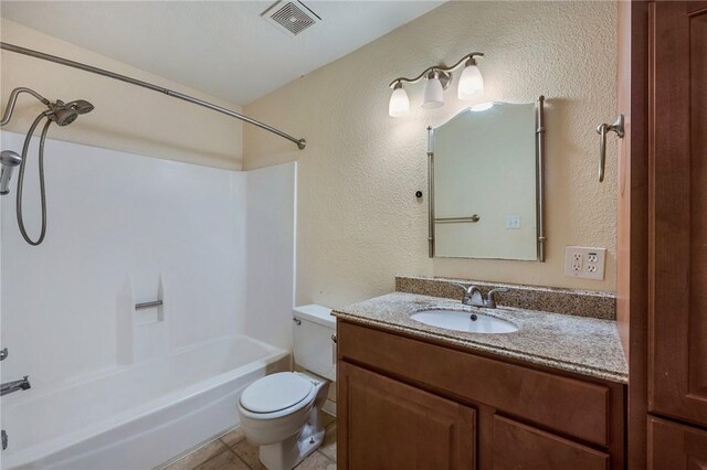 bathroom with visible vents, a textured wall, toilet, bathing tub / shower combination, and vanity