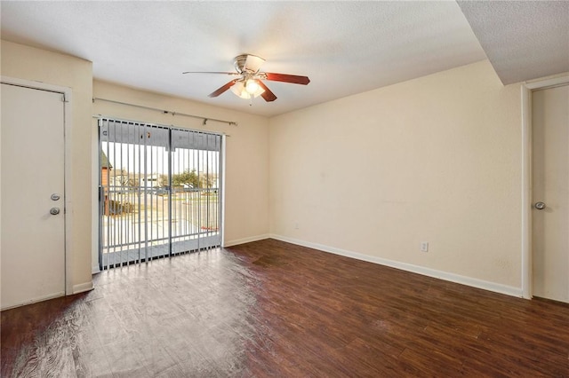 empty room with a ceiling fan, a textured ceiling, baseboards, and wood finished floors