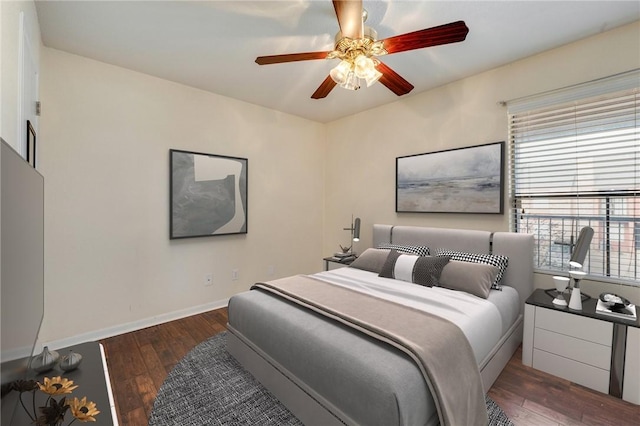 bedroom with ceiling fan, baseboards, and wood finished floors