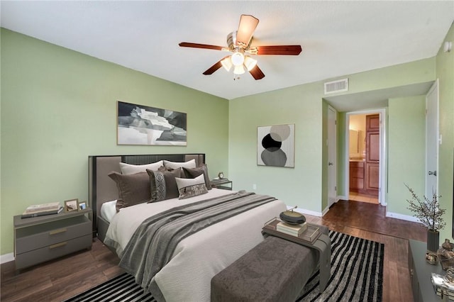 bedroom with a ceiling fan, wood finished floors, visible vents, and baseboards