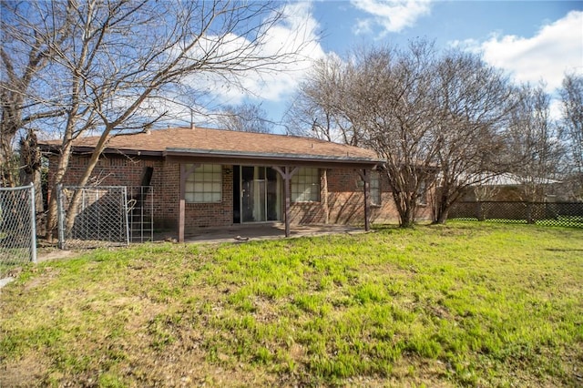 back of house featuring a lawn and a patio