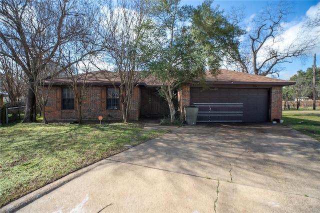 ranch-style house featuring a garage and a front lawn