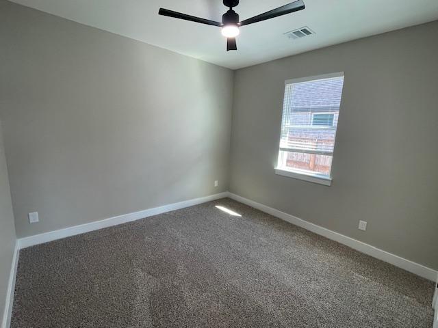 carpeted empty room featuring ceiling fan