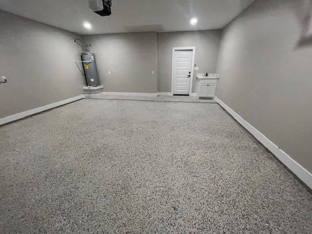 interior space with a garage door opener and gas water heater