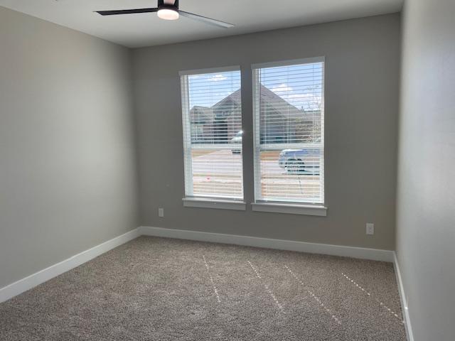 spare room featuring carpet floors and ceiling fan