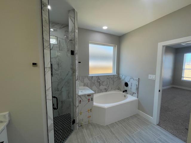 bathroom with independent shower and bath and vanity