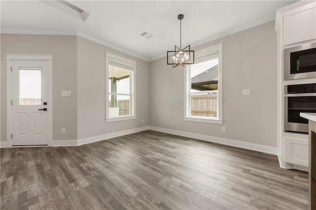 2908 Goldberg Dr, Bryan, TX 77808 - unfurnished dining area featuring ornamental molding, a chandelier, wood finished floors, and baseboards