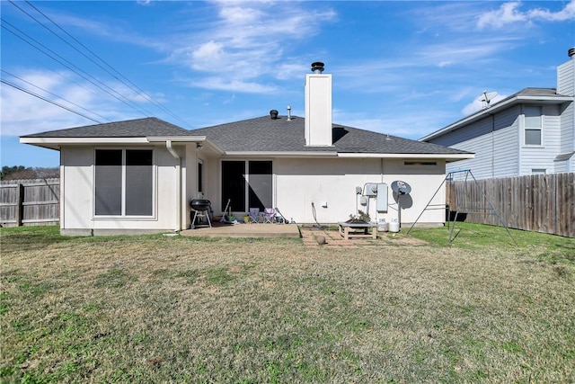 back of house with a lawn