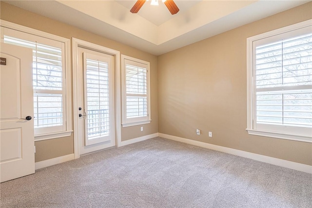 unfurnished room with plenty of natural light, ceiling fan, baseboards, and carpet floors