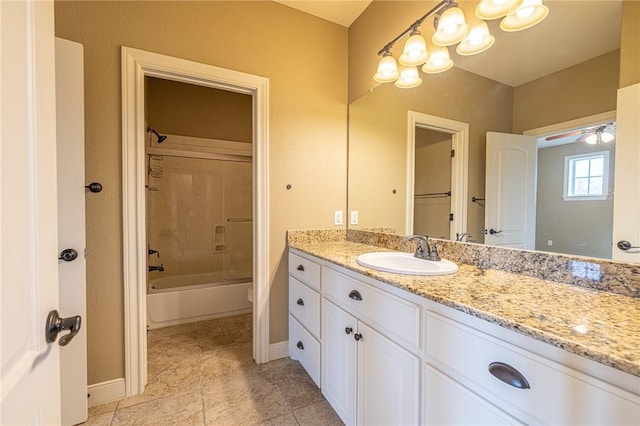 full bathroom featuring vanity, bathing tub / shower combination, toilet, and baseboards