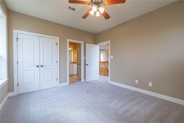 unfurnished bedroom with visible vents, a ceiling fan, a closet, baseboards, and light colored carpet