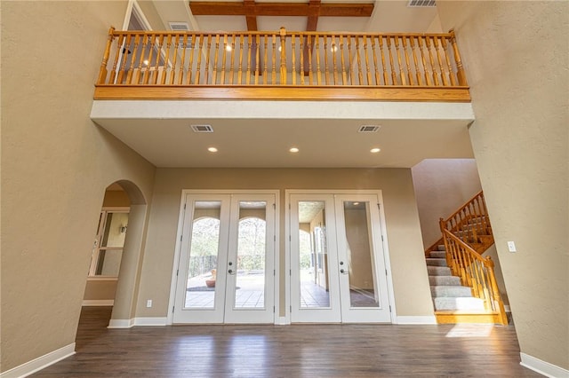 foyer with wood finished floors, french doors, baseboards, and visible vents