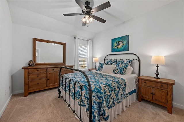 bedroom featuring ceiling fan, light colored carpet, and vaulted ceiling