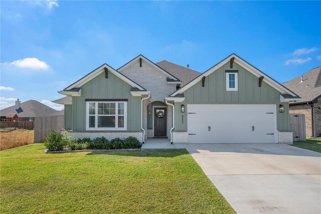 2909 Captain Ct, Bryan, TX 77808 - view of front of home with a garage and a front lawn