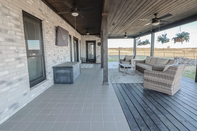 view of patio featuring ceiling fan, an outdoor hangout area, and a wooden deck