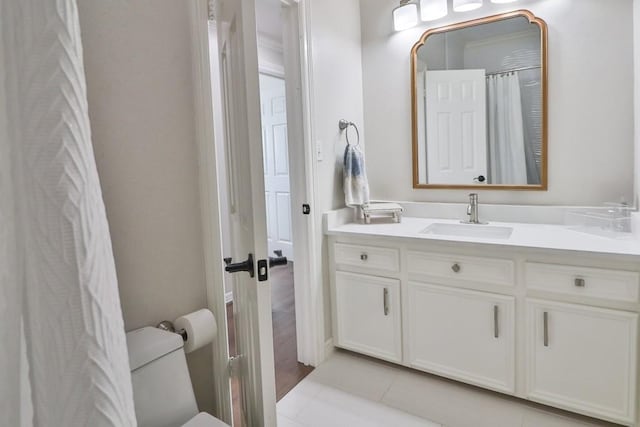 bathroom featuring toilet, tile patterned floors, and vanity