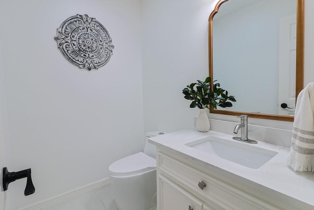 bathroom featuring toilet, vanity, and tile patterned flooring