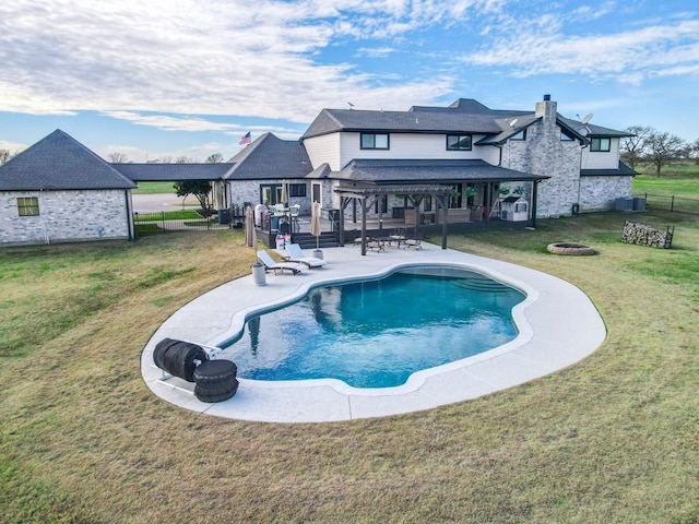 view of pool with a pergola, a fire pit, central AC unit, a yard, and a patio