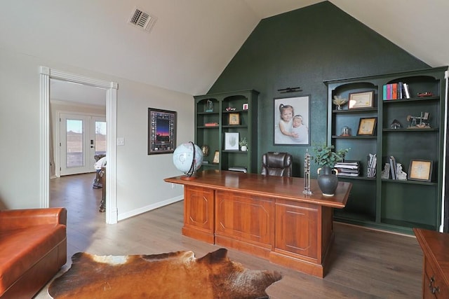 office space with wood-type flooring, built in features, lofted ceiling, and french doors