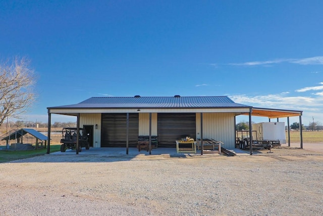 rear view of property featuring an outbuilding