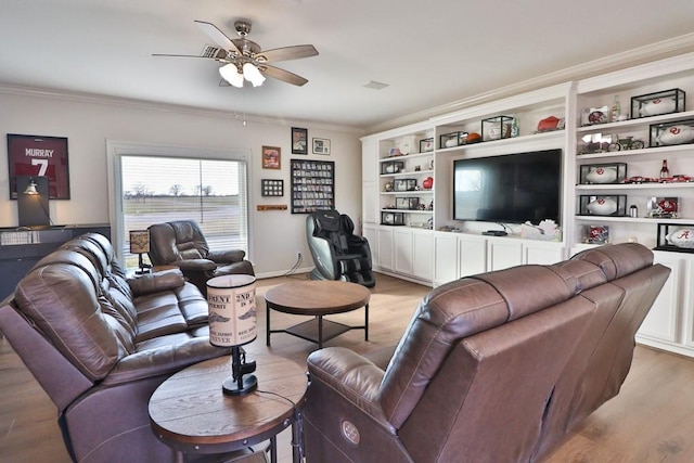 living room featuring ceiling fan, light wood-type flooring, and crown molding