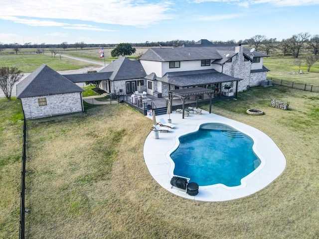 view of swimming pool with a lawn, an outdoor fire pit, a pergola, and a wooden deck