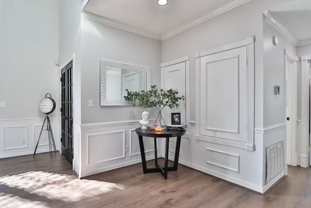 foyer entrance featuring dark hardwood / wood-style flooring and ornamental molding