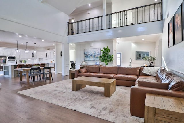 living room featuring hardwood / wood-style flooring and a high ceiling