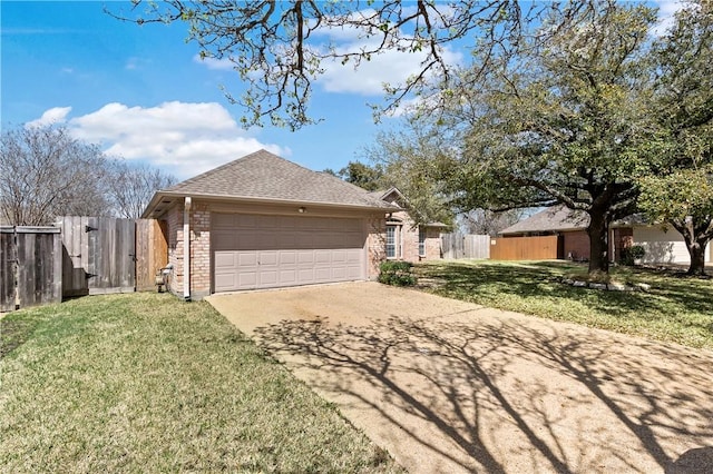 view of front facade featuring a front yard, brick siding, driveway, and fence