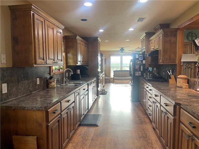 16659 Hwy 90 N, Bedias, TX 77831 - kitchen featuring a sink, a ceiling fan, recessed lighting, light wood-style flooring, and decorative backsplash