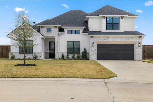 view of front of home with a front lawn and a garage