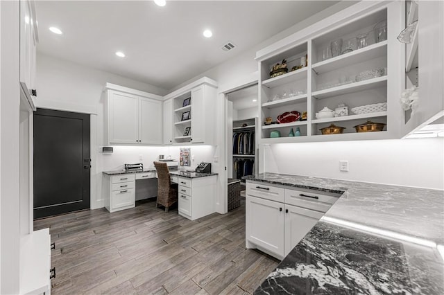 home office featuring recessed lighting, visible vents, built in desk, and wood finished floors