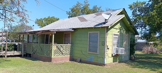 view of home's exterior with a lawn and covered porch