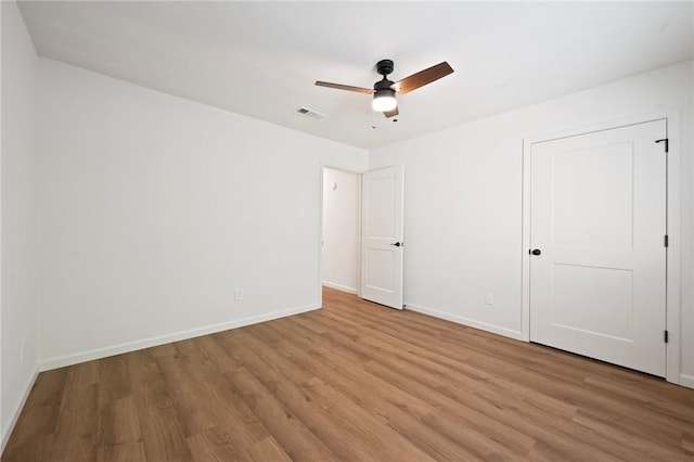 2800 Longmire Dr Unit 22, College Station, TX 77845 - unfurnished bedroom with light wood finished floors, baseboards, and ceiling fan