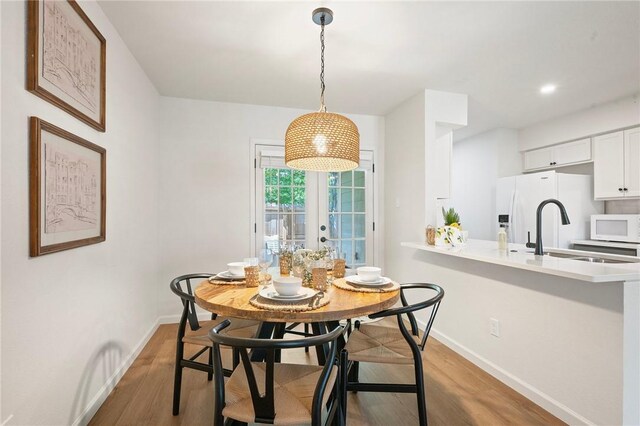 2800 Longmire Dr Unit 22, College Station, TX 77845 - dining room featuring baseboards, light wood finished floors, and french doors