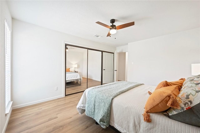 2800 Longmire Dr Unit 22, College Station, TX 77845 - bedroom with light wood finished floors, a closet, baseboards, ceiling fan, and multiple windows
