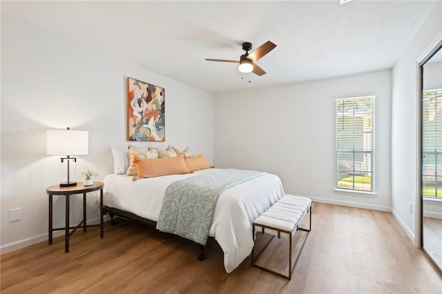 2800 Longmire Dr Unit 22, College Station, TX 77845 - bedroom with wood finished floors, baseboards, and a ceiling fan