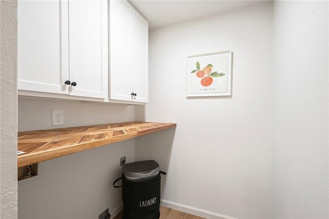 2800 Longmire Dr Unit 22, College Station, TX 77845 - clothes washing area featuring cabinet space and light wood-type flooring