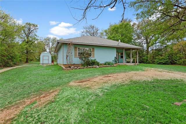 view of front of house with an outdoor structure, a storage shed, and a front yard