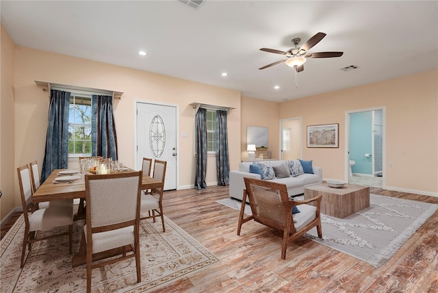 living room with a ceiling fan, light wood finished floors, baseboards, visible vents, and recessed lighting