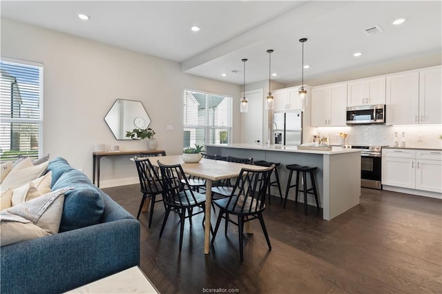 dining area with dark wood-type flooring, recessed lighting, baseboards, and visible vents