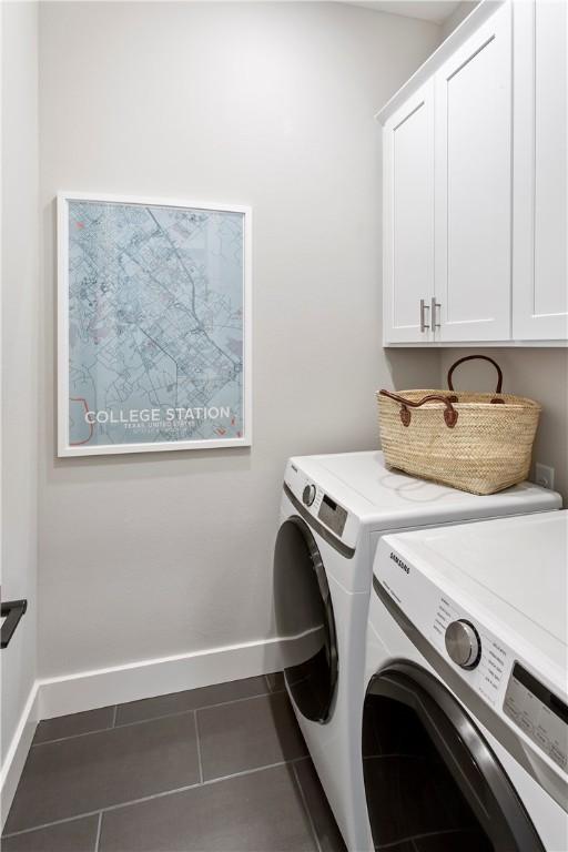 242 Estates Cir, College Station, TX 77840 - laundry room with cabinet space, washing machine and clothes dryer, baseboards, and dark tile patterned flooring