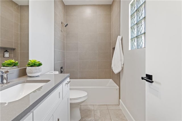 bathroom with tile patterned flooring, vanity, toilet, baseboards, and shower / bathing tub combination