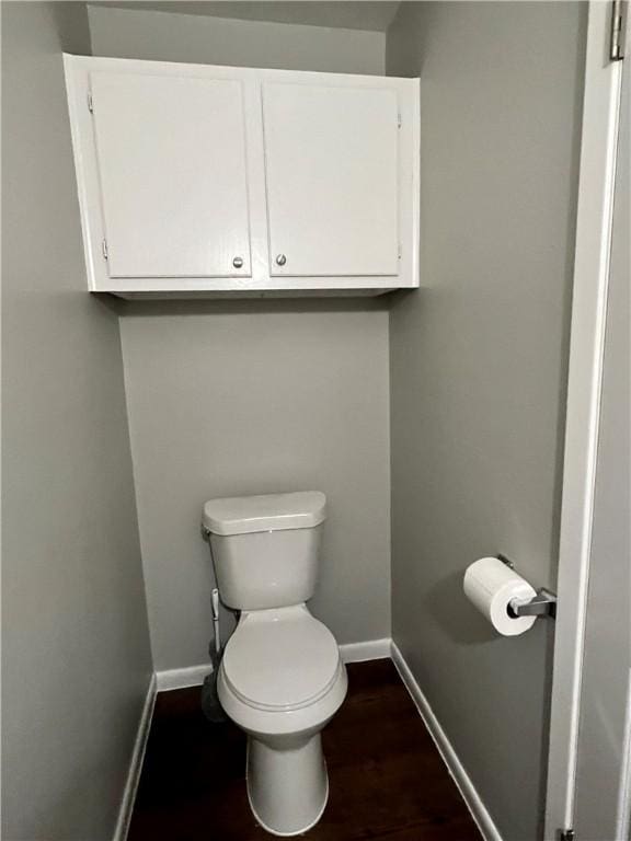 bathroom with wood-type flooring and toilet