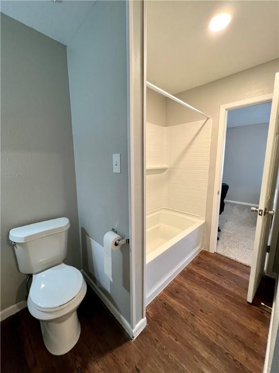 bathroom featuring walk in shower, toilet, and hardwood / wood-style flooring