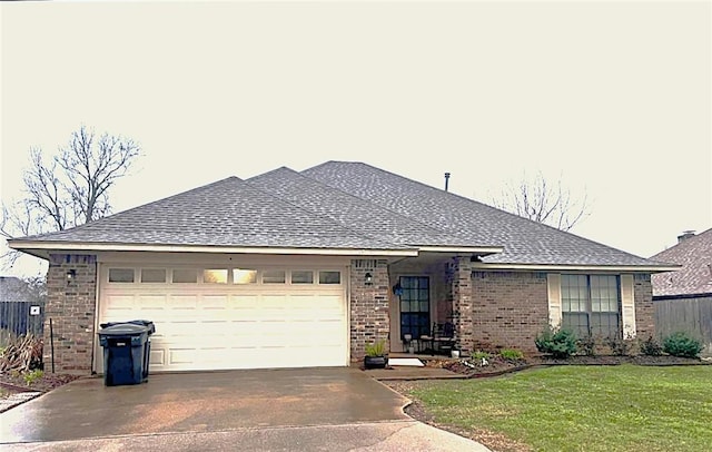 single story home featuring an attached garage, brick siding, a shingled roof, driveway, and a front lawn